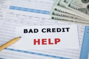 “Bad credit help” sign with financial documents and U.S. currency, illustrating how Chapter 7 bankruptcy affects credit reports in Oregon.