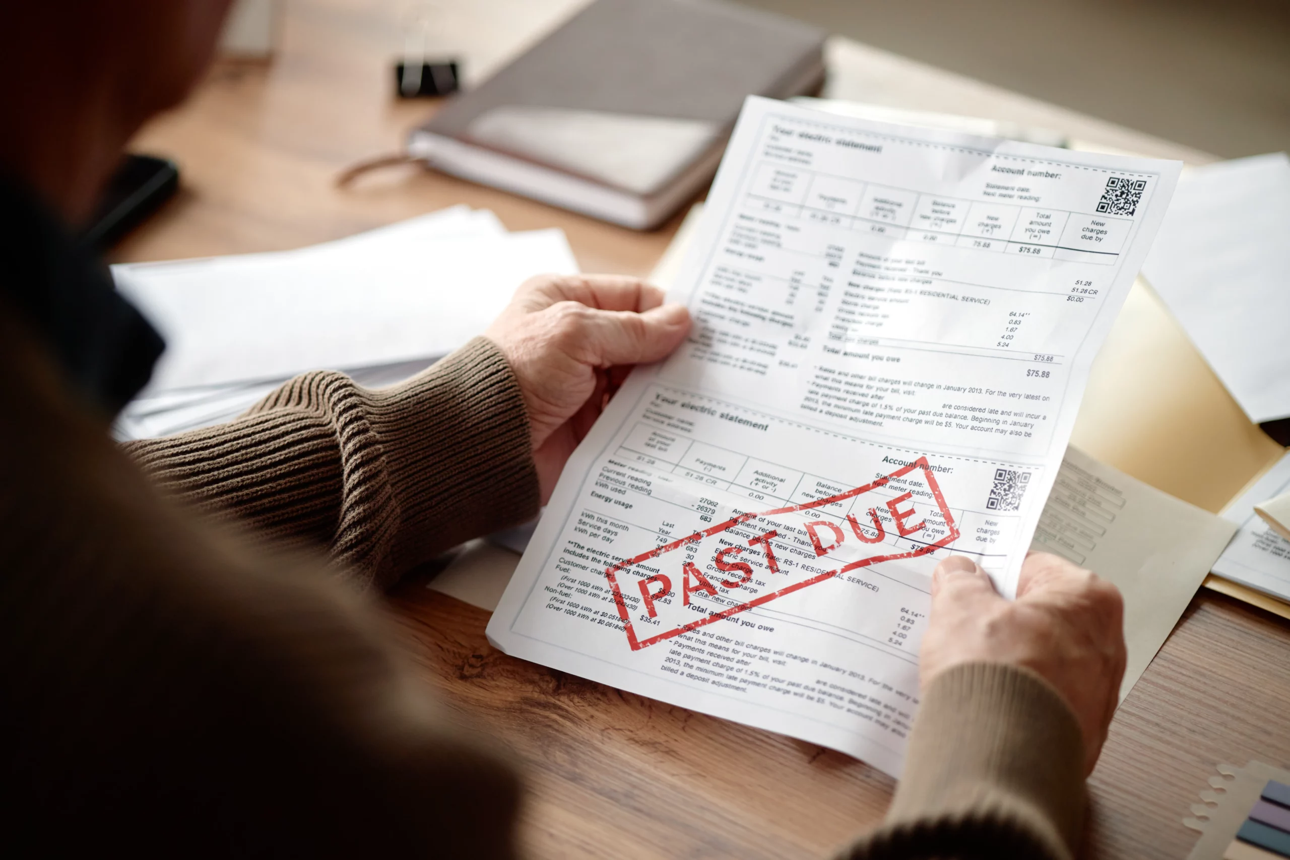 Person holding a past-due bill, illustrating considerations for filing Chapter 7 bankruptcy twice in Oregon.