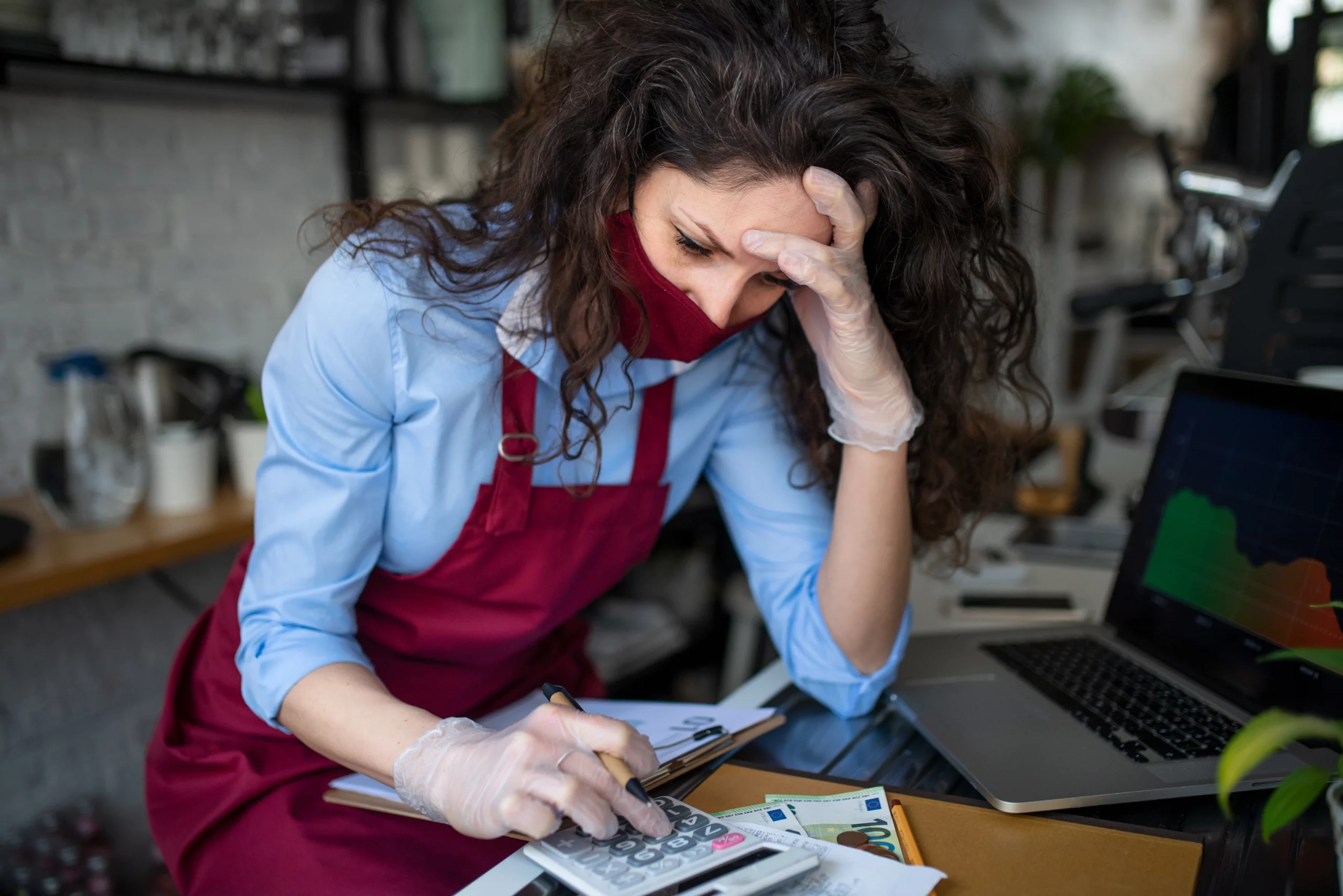 Stressed small business owner reviewing financial figures, illustrating Subchapter V bankruptcy options for small businesses in Oregon.