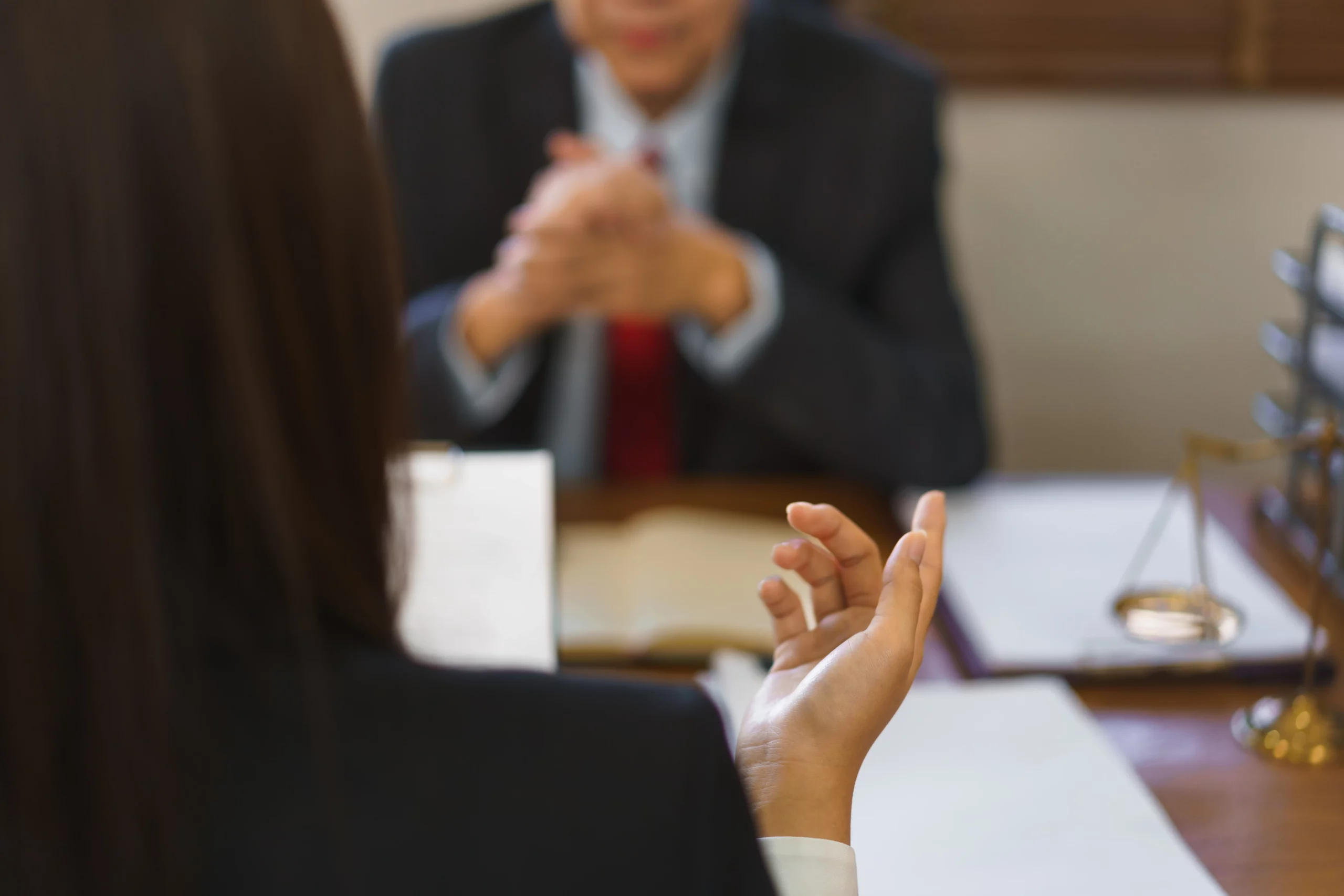 Woman consulting with a bankruptcy lawyer at a desk, discussing the Chapter 13 bankruptcy timeline in Oregon.